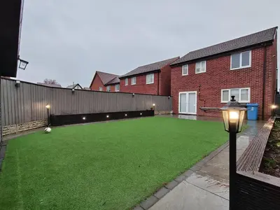a large artificial lawn in front of a brick building at Hanani House in Liverpool