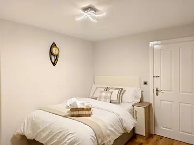 a bedroom with a bed with a ceiling fan at Hanani House in Liverpool