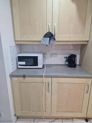 a microwave sitting on a counter in a kitchen at Nightingale Roomz in Lower Darwen