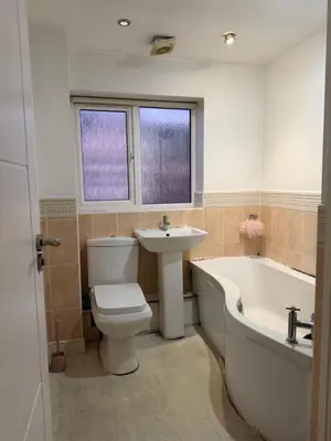a bathroom with a tub and a toilet and a sink at Nightingale Roomz in Lower Darwen
