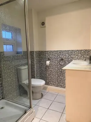 a bathroom with a toilet and a sink at Nightingale Roomz in Lower Darwen