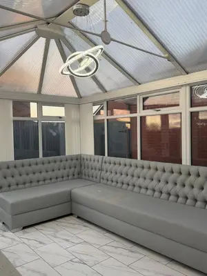 a bench in a room with windows and a ceiling at Nightingale Roomz in Lower Darwen