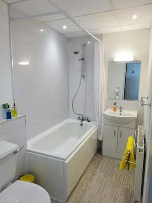 a bathroom with a tub and a toilet and a sink at Shipping Lanes Hotel in Morecambe