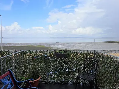 two chairs sitting on a balcony looking at the ocean at Shipping Lanes Hotel in Morecambe