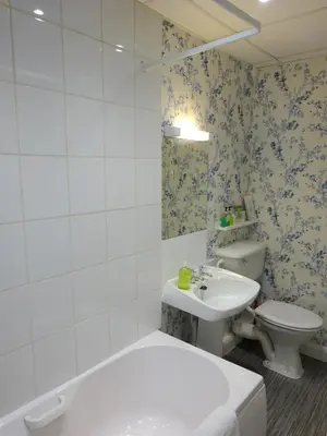 a bathroom with a toilet and a sink at Shipping Lanes Hotel in Morecambe