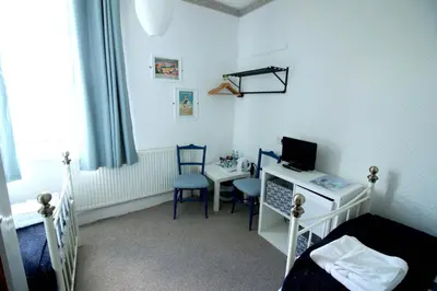 a bedroom with a desk and a bed with a computer at Shipping Lanes Hotel in Morecambe