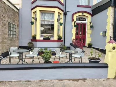 a group of chairs and tables in front of a building at The Castleton in Blackpool