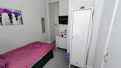 a bedroom with a purple bed and a mirror at The Castleton in Blackpool
