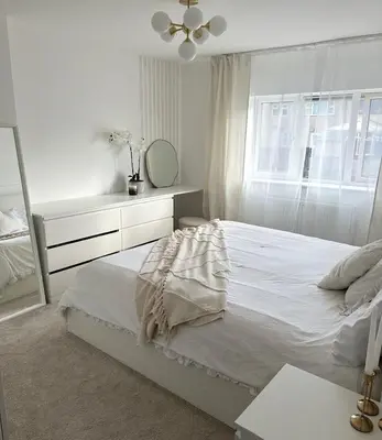a white bedroom with a bed and a mirror at Luxurious Ribble Valley Home in Clitheroe
