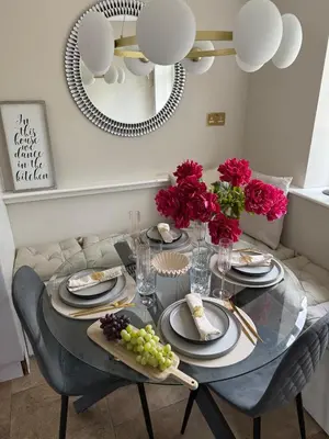 a dining room table with plates of food and flowers at Luxurious Ribble Valley Home in Clitheroe