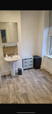 a bathroom with a white sink and a counter at The Victorian Terrace in Morecambe