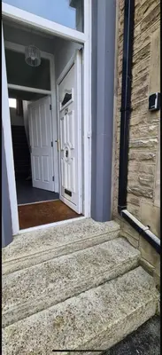 an entrance to a house with a white door at The Victorian Terrace in Morecambe