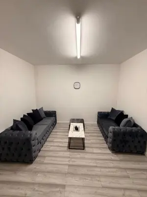 a living room with two couches and a table at Stylish Dream Home with 4 En-Suite Bedrooms in Liverpool