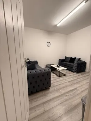 a living room with two couches and a table at Stylish Dream Home with 4 En-Suite Bedrooms in Liverpool