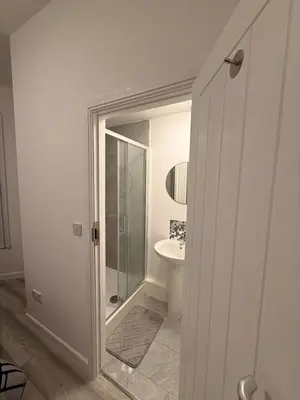 a bathroom with a shower and a toilet and a sink at Stylish Dream Home with 4 En-Suite Bedrooms in Liverpool
