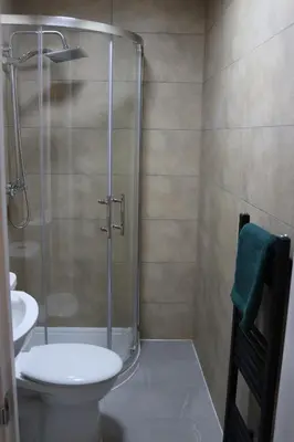 a bathroom with a shower and a toilet and a sink at Anfield 5bed 5bath cosy group retreat in Liverpool