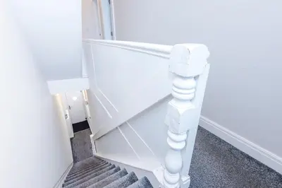 a stairway with a white stair railing and a stair case at Spacious 6-Bedroom Central Blackpool in Blackpool