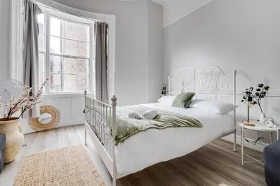 a white bedroom with a white bed and a window at Central L1 Stay, Close to all Attractions, Parking Nearby in Liverpool