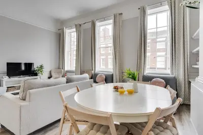 a white living room with a white table and chairs at Central L1 Stay, Close to all Attractions, Parking Nearby in Liverpool