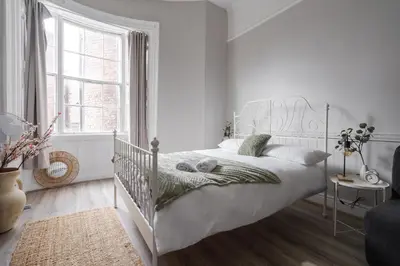 a white bedroom with a white bed and a window at Central L1 Stay, Close to all Attractions, Parking Nearby in Liverpool