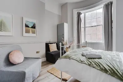 a white bedroom with a bed and a window at Central L1 Stay, Close to all Attractions, Parking Nearby in Liverpool