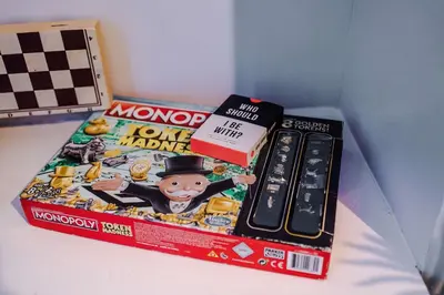 a box of monopoly and a monopoly game on a table at Monthly & Weekly Offers , Pool Table , PS4 , Liverpool , 3 Bed House , Ideal For Contractors , Relocation & Family Stays in Litherland
