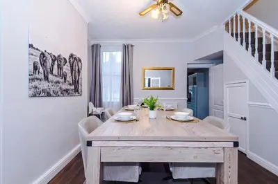 a dining room with a wooden table and chairs at Monthly & Weekly Offers , Pool Table , PS4 , Liverpool , 3 Bed House , Ideal For Contractors , Relocation & Family Stays in Litherland