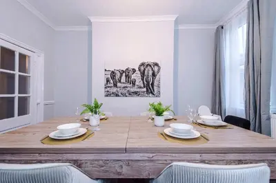 a dining room with a wooden table with chairs at Monthly & Weekly Offers , Pool Table , PS4 , Liverpool , 3 Bed House , Ideal For Contractors , Relocation & Family Stays in Litherland