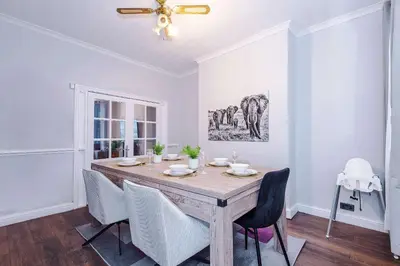 a dining room with a wooden table and chairs at Monthly & Weekly Offers , Pool Table , PS4 , Liverpool , 3 Bed House , Ideal For Contractors , Relocation & Family Stays in Litherland