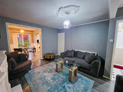 a living room with a couch and a table at Amazing Spacious 3BDR Home Near LFC Stadium in Liverpool