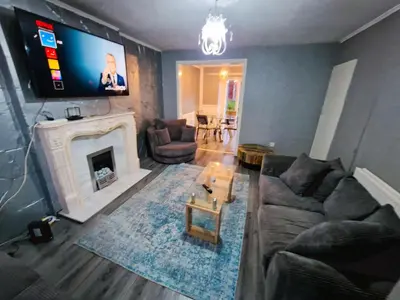 a living room with a couch and a fireplace at Amazing Spacious 3BDR Home Near LFC Stadium in Liverpool