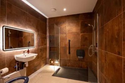 a bathroom with a shower and a sink at The Terrace - A St David Aparthotel in Barrow