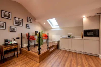a kitchen with white cabinets and a window at The Terrace - A St David Aparthotel in Barrow