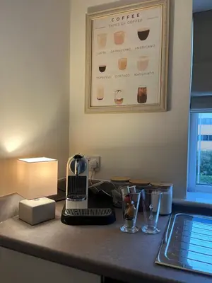 a kitchen counter with a laptop on a table at Sustainable Habitats- Berkley House apartment in Blackpool