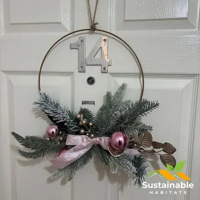 a christmas wreath on a door with a number at Sustainable Habitats- Berkley House apartment in Blackpool