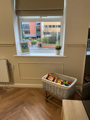 a room with a basket of toys in front of a window at Sustainable Habitats- Berkley House apartment in Blackpool