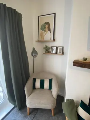 a chair with a pillow in a living room at Slick Space for a Wigan Stay - 5 Minutes from M6 and M58 Motorways in Pemberton