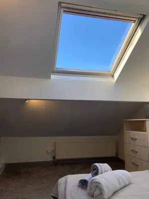 a bedroom with a large window in the ceiling at Skylight Loft, 2 bed apartment, central Lancaster in Lancaster