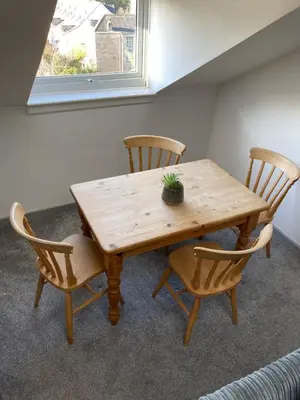 a wooden table and chairs with a potted plant on it at Skylight Loft, 2 bed apartment, central Lancaster in Lancaster