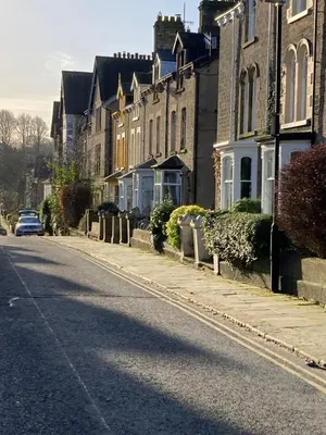 a street with houses and a car on the road at Skylight Loft, 2 bed apartment, central Lancaster in Lancaster