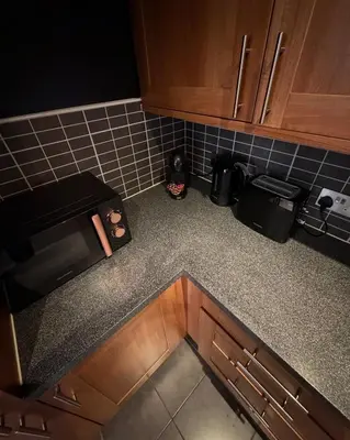an overhead view of a kitchen counter top with a microwave at Central Liverpool 2-Bed Balcony Apartment by StaySavvy Accommodation in Liverpool