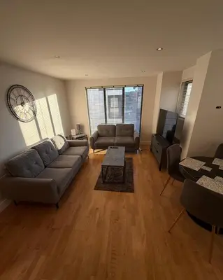 a living room with a couch and a tv at Central Liverpool 2-Bed Balcony Apartment by StaySavvy Accommodation in Liverpool