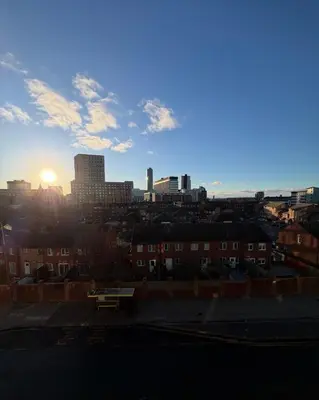 a view of a city skyline with the sun setting at Central Liverpool 2-Bed Balcony Apartment by StaySavvy Accommodation in Liverpool