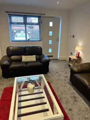 a living room with a couch and a glass table at Cosy flat Lytham St Annes - Sleeps 2 with parking in Lytham St Annes