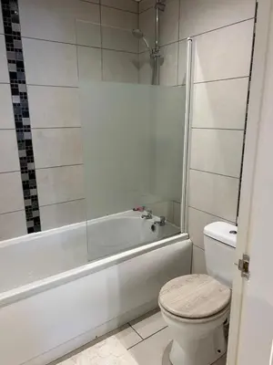 a bathroom with a white tub and a toilet at Cosy flat Lytham St Annes - Sleeps 2 with parking in Lytham St Annes