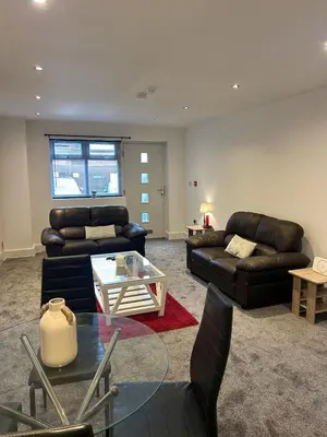 a living room with two couches and a table at Cosy flat Lytham St Annes - Sleeps 2 with parking in Lytham St Annes
