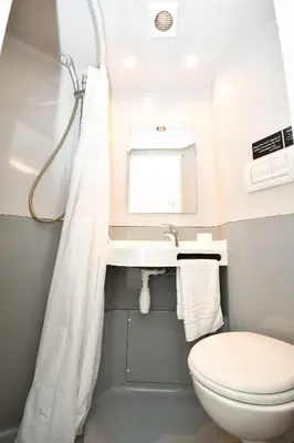 a bathroom with a toilet and a sink at Modern & Convenient 4 Bed Apartment in Liverpool in Liverpool