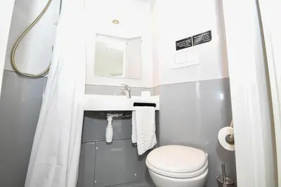 a small bathroom with a toilet and a sink at Modern & Convenient 4 Bed Apartment in Liverpool in Liverpool