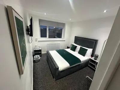a bedroom with a bed and a window at NEW PCK Thas Hotel BLACKPOOL in Blackpool