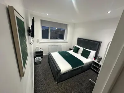 a bedroom with a bed and a window at NEW PCK Thas Hotel BLACKPOOL in Blackpool